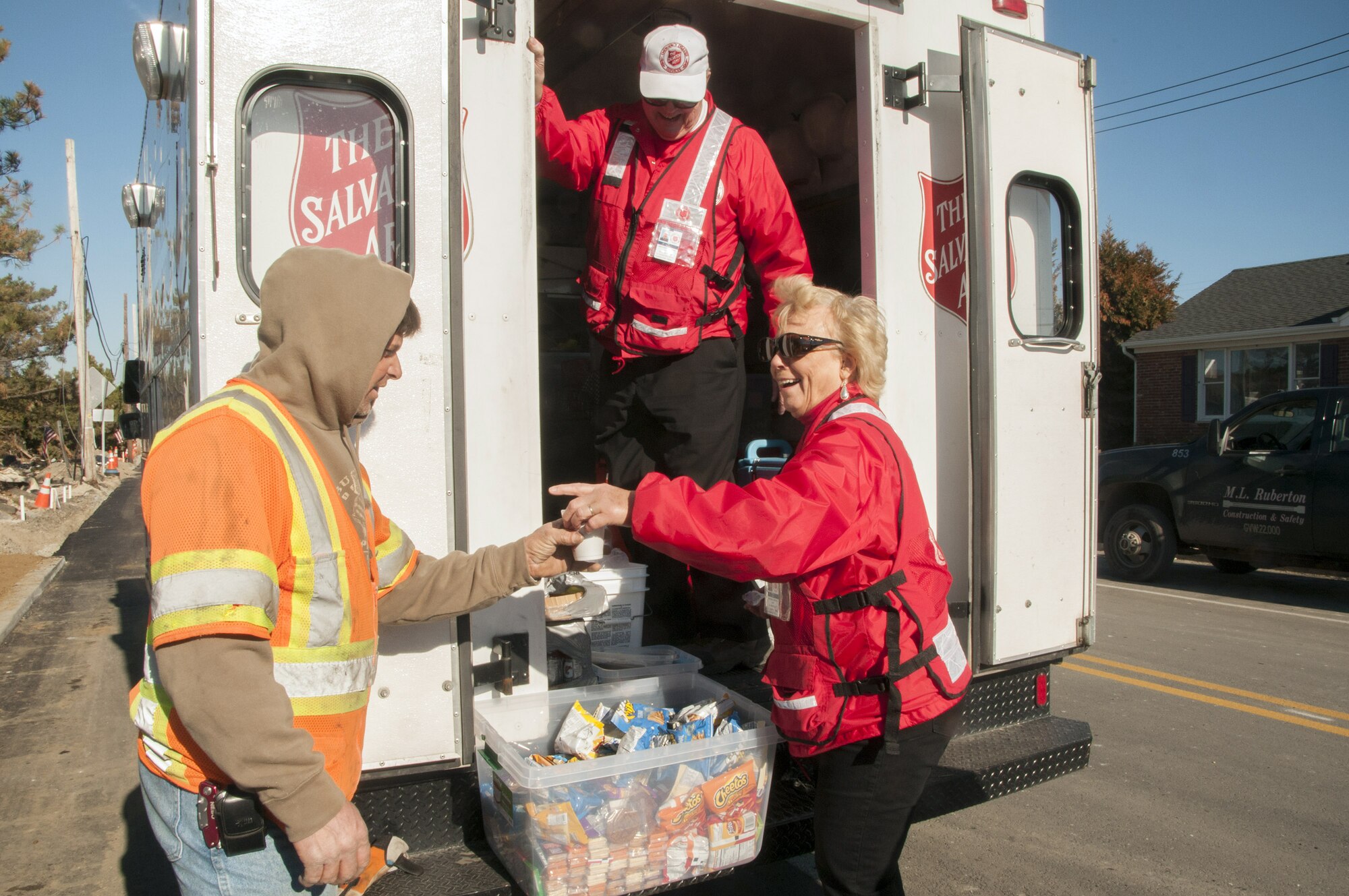 Members of the Salvation Army give coffee to a construction worker in Manatoloking, N.J. The Salvation Army is providing food and other supplies to residents and others in areas affected by Hurricane Sandy. (Photo by Patsy Lynch/FEMA) 