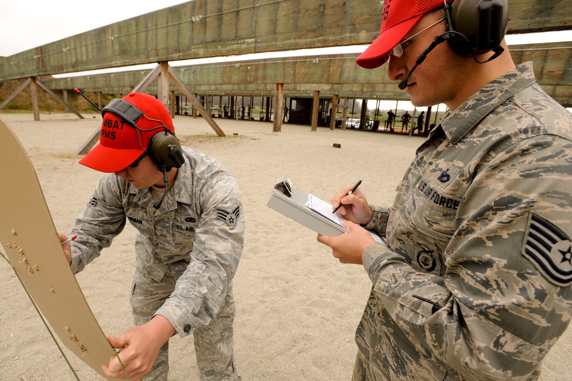 VANDENBERG AIR FORCE BASE, Calif. – Tallying scores Senior Airman Nathan Lowman, 30th Security Forces Squadron combat arms instructor, and Tech. Sgt. Jason O’Hare, 30th SFS CATM instructor, add up the shooters points during an Elementary Level Excellence Competition here Monday, April 15, 2013. The 30th SFS CATM instructors held a two day competition for rifles and pistols, which was open to all base military members willing to shoot.  (U.S. Air Force photo/Airman Yvonne Morales)