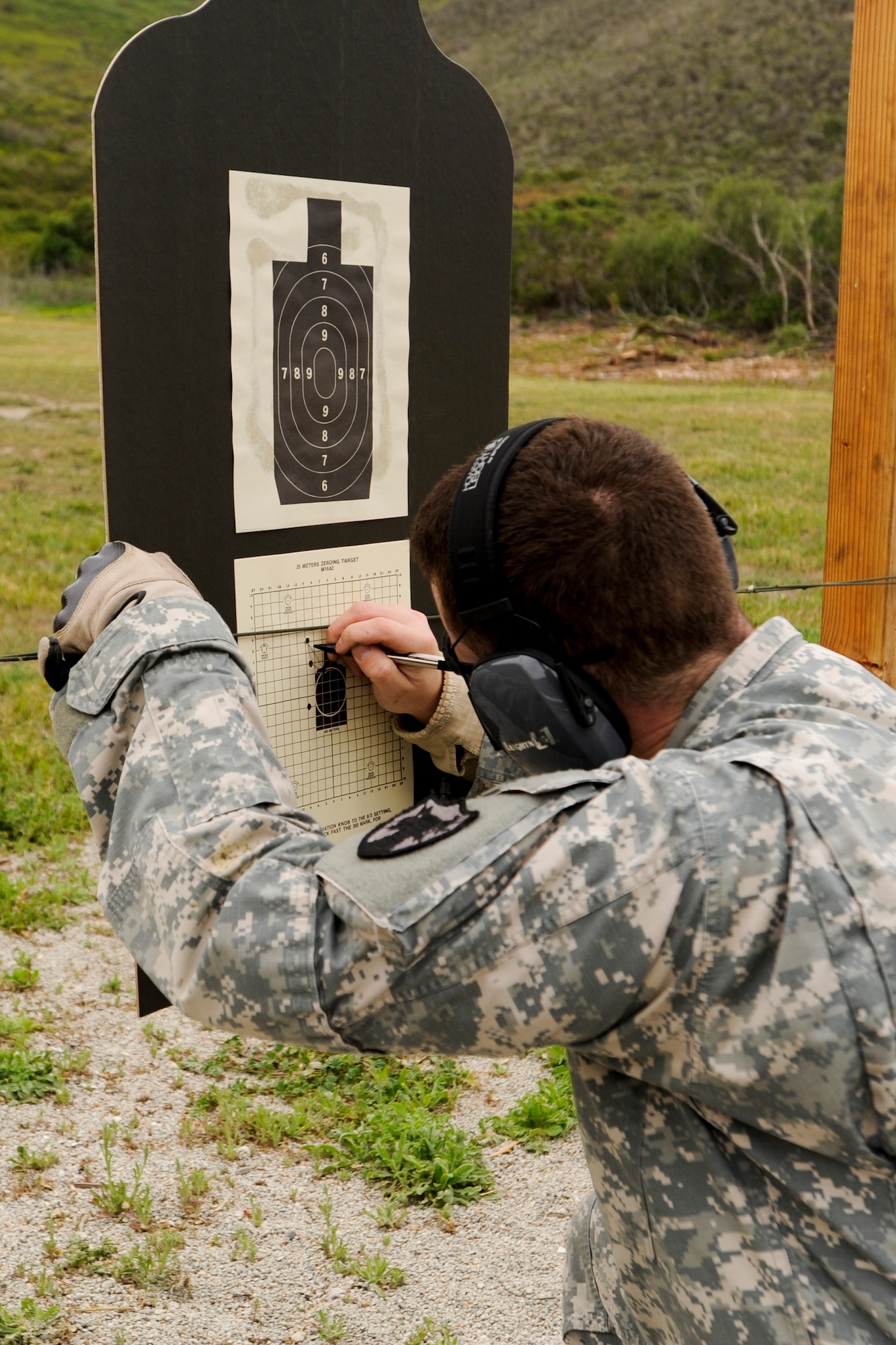 VANDENBERG AIR FORCE BASE, Calif. – U.S. Army Capt. James Kirby, Joint Functional Component Command for Space deliberate planner, reviews a target for site corrections here during an Elementary Level Excellence Competition here Monday, April 15, 2013. The 30th Security Forces Squadron Combat Arms Training instructors held a two day competition for rifles and pistols, which was open to all base military members willing to shoot. (U.S. Air Force photo/Airman Yvonne Morales)