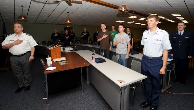 Members of the Civil Air Patrol Rushmore Composite Squadron stand and recite the Pledge of Allegiance during a monthly meeting at Ellsworth Air Force Base, S.D., March 25, 2013. CAP is the official Air Force auxiliary, and a national community service organization made up of trained civilian volunteers. (U.S. Air Force photo by Airman 1st Class Anania Tekurio/Released)  