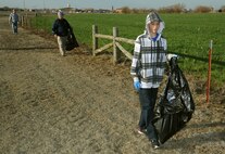 Patrick Brandley, 12, the son of Master Sgt. Phillip Brandley, the 71st Medical Group first sergeant; picks up trash April 6 on Gott Road outside the Hairston Gate at Vance Air Force Base, Okla. (U.S. Air Force photo/ Staff Sgt. James Bolinger)