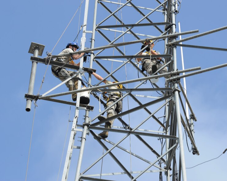 Airmen from the 2nd Communications Squadron cable antenna maintenance remove an antenna on a tower on Barksdale Air Force Base, La., April 17, 2013. The antenna is being removed because it blocks the ladder making it difficult to perform maintenance on the tower. (U.S. Air Force photo/Senior Airman Sean Martin)