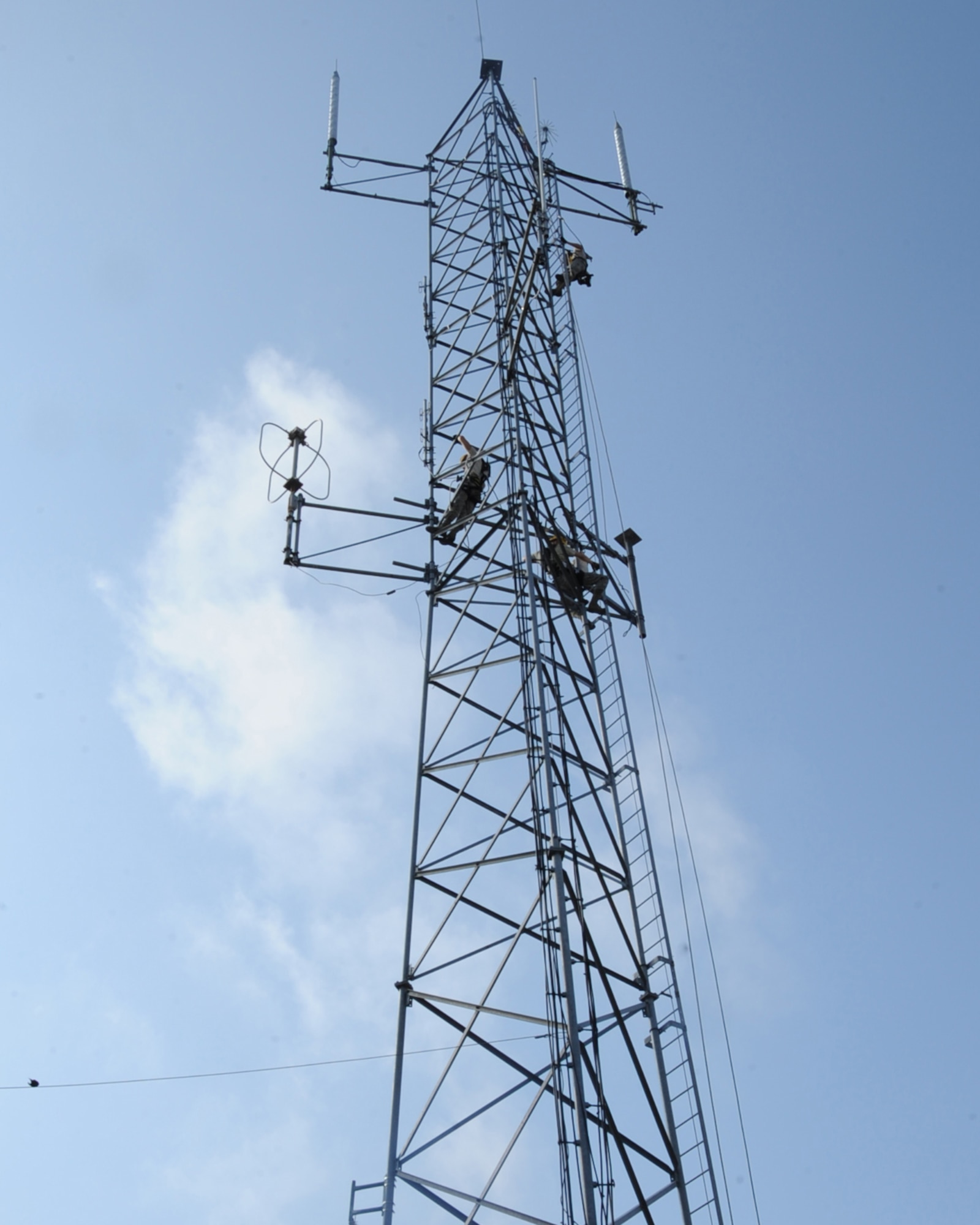 Airmen from the 2nd Communications Squadron cable antenna maintenance remove an antenna from a tower on Barksdale Air Force Base, La., April 17, 2013. The antenna is being removed because it blocks the ladder making it difficult to perform maintenance on the tower. (U.S. Air Force photo/Senior Airman Sean Martin)