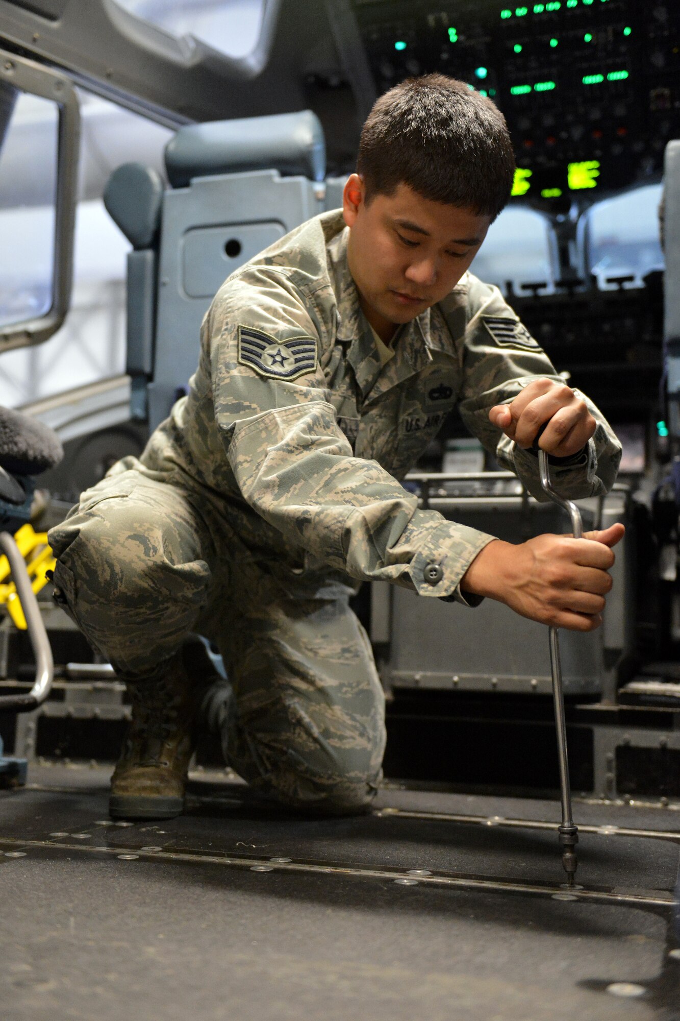 Staff Sgt. Joshua Minoda, 62nd Maintenance Squadron crew chief, prepares a C-17 Globemaster III flight deck for the installation of aircraft armor, April 12, 2013 at Joint Base Lewis-McChord, Wash. Minoda was named the Air Mobility Command Crew Chief of the Year for 2012. (U.S. Air Force photo/Airman 1st Class Jacob Jimenez)