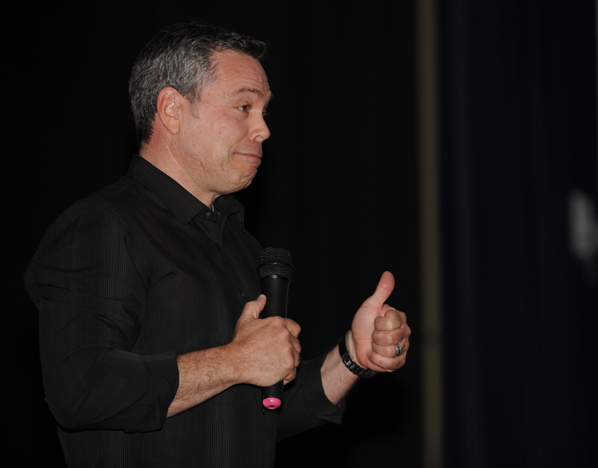Bernie McGrenahan talks with 375th Air Mobility Wing Airmen during his "Happy Hour" comedy tour April 11 at the base auditorium.  McGrenahan is a stand-up comedian who tours military installations and talks about alcohol, drug, suicide, and sexual assault prevention.  The first 30 minutes of his show is a comedy routine.  The last half of the show, he transitioned into his life experiences and how he dealt with alcohol and family troubles.  He has been alcohol and drug free for 24 years. (U.S. Air Force photo/Staff Sgt. Maria Bowman)
