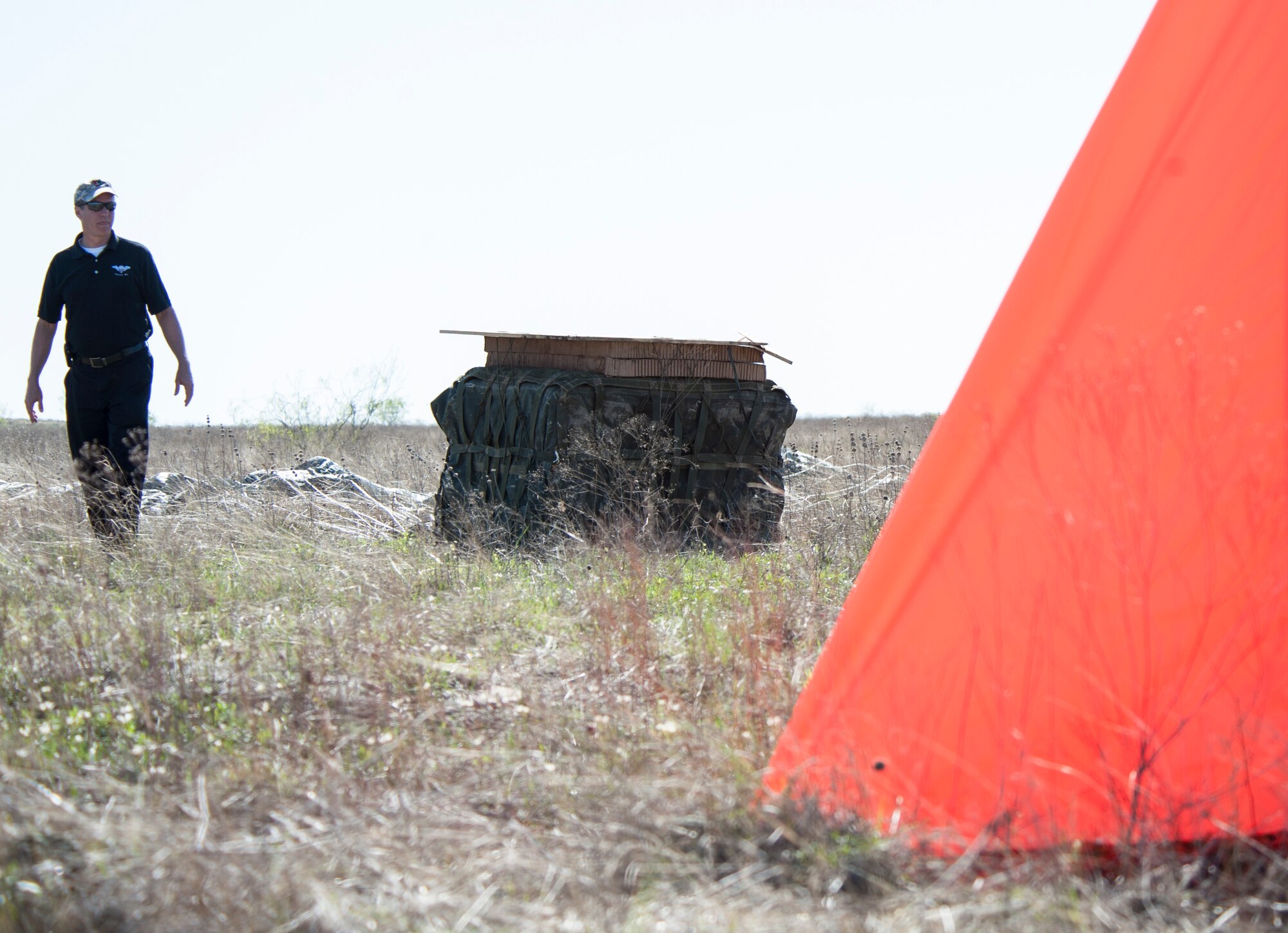 Richard Benney, Natick Director of aerial delivery, inspects how close the Joint Precision Airdrop System (JPADS) bundles landed to the designated target during the first Big Country JPADS Capabilities Training Exercise April 11, 2013, at Fort Hood, Texas. The exercise was conducted to test the capabilities of the system and gather important data which will improve its effectiveness and accuracy. (U.S. Air Force photo by Airman 1st Class Jonathan Stefanko/Released)