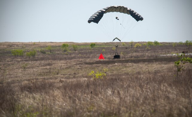 A Joint Precision Airdrop System (JPADS) bundle lands at its designated target during the first Big Country JPADS Capabilities Training Exercise April 11, 2013, at Fort Hood, Texas. Traditional airdrops by Air Force airlifters are at altitudes of 400-1,000 feet. With JPADS, those same bundles can be dropped and guided from altitudes as high as 25,000 feet with pinpoint accuracy allowing the aircraft to safely avoid enemy ground fire. (U.S. Air Force photo/Airman 1st Class Jonathan Stefanko)