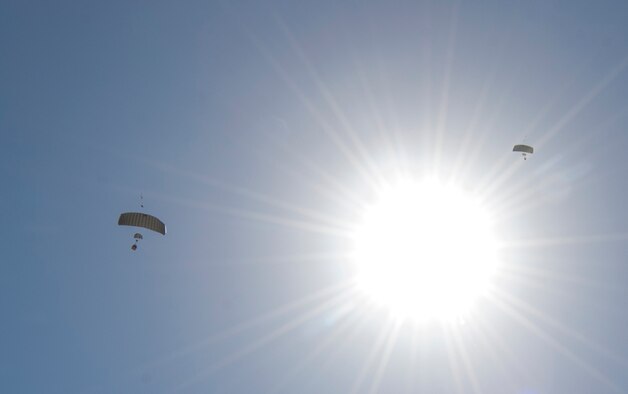 Two Joint Precision Airdrop System bundles (JPADS) glide to their targets during the first Big Country JPADS Capabilities Training Exercise April 11, 2013, at Fort Hood, Texas. JPADS can be guided to designated drop zones by aircrew to decrease the time ground forces are exposed to enemy fire. (U.S. Air Force photo/Airman 1st Class Jonathan Stefanko)