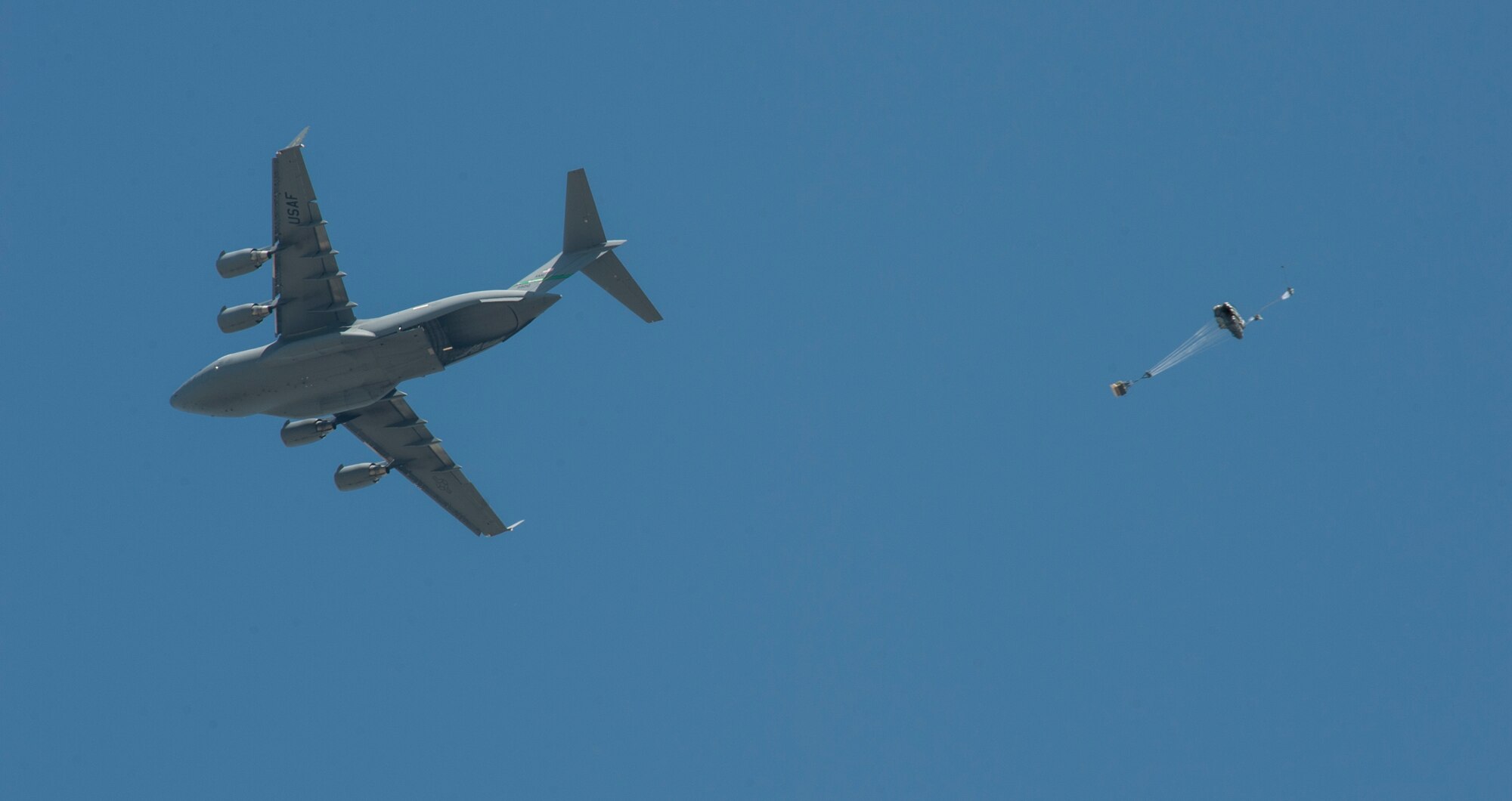 A C-17 assigned to the 62nd Airlift Wing, Joint Base Lewis-McChord, Wash., drops a Joint Precision Airdrop System (JPADS) bundle during the first Big Country JPADS Capabilities Training Exercise April, 11, 2013, at Fort Hood, Texas. JPADS is a system that can be dropped and guided from as high as 25,000 feet with pinpoint accuracy, allowing the aircraft to safely avoid enemy ground fire. (U.S. Air Force photo by Airman 1st Class Jonathan Stefanko/ Released)