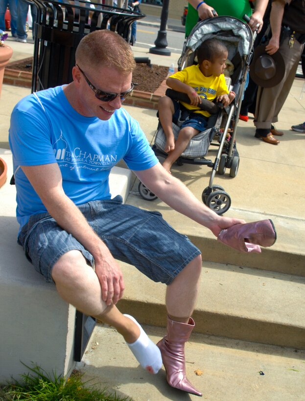 A walker examines his bloody foot after the “Walk a Mile in Her Shoes” event April 13, 2013, in Hampton, Va. The pain felt by the walkers serves to emulate a fraction of the pain felt by sexual assault victims worldwide. (U.S. Air Force photo by Airman 1st Class Austin Harvill/Released)