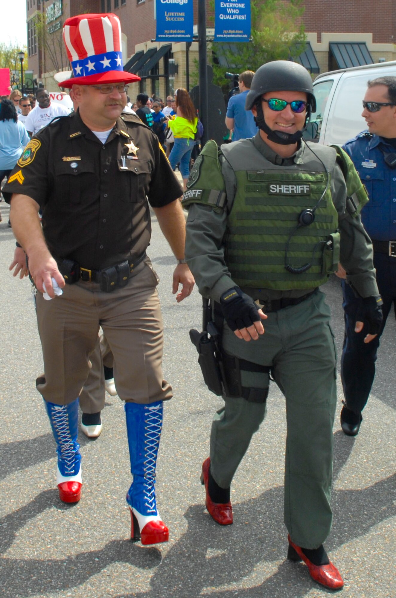 A group of law-enforcement officials round a corner during the “Walk a Mile in Her Shoes” event in Hampton, Va., April 13, 2013. Initially, the event was intended for men only back in 2001, but since has become a family event. (U.S. Air Force photo by Airman 1st Class Austin Harvill/Released)