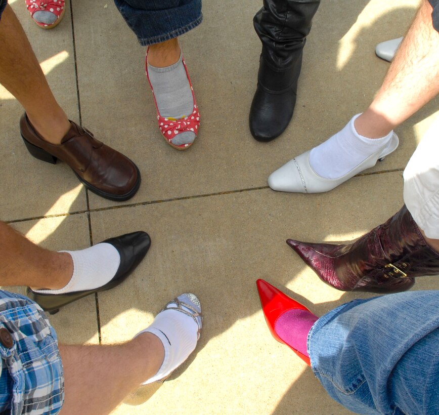 Airmen from the 633rd Communications Squadron show off their heels before the annual “Walk a Mile in Her Shoes” event in Hampton, Va., April 13, 2013. Airmen from Langley Air Force Base, Va., proved to victims that sexual violence won’t be tolerated in our community by donning heels for the mile-long walk. (U.S. Air Force photo by Airman 1st Class Austin Harvill/Released)
