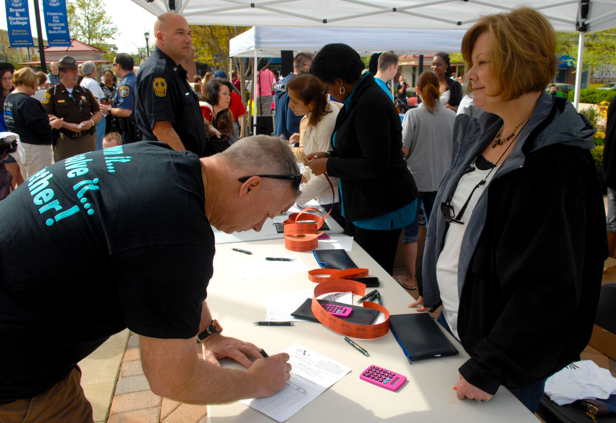 A Service member signs up to participate in the “Walk a Mile in Her Shoes” event in Hampton, Va., April 13, 2013. Approximately 150 walkers participated in the event, many of whom brought friends and families to help show support. (U.S. Air Force photo by Airman 1st Class Austin Harvill/Released)
