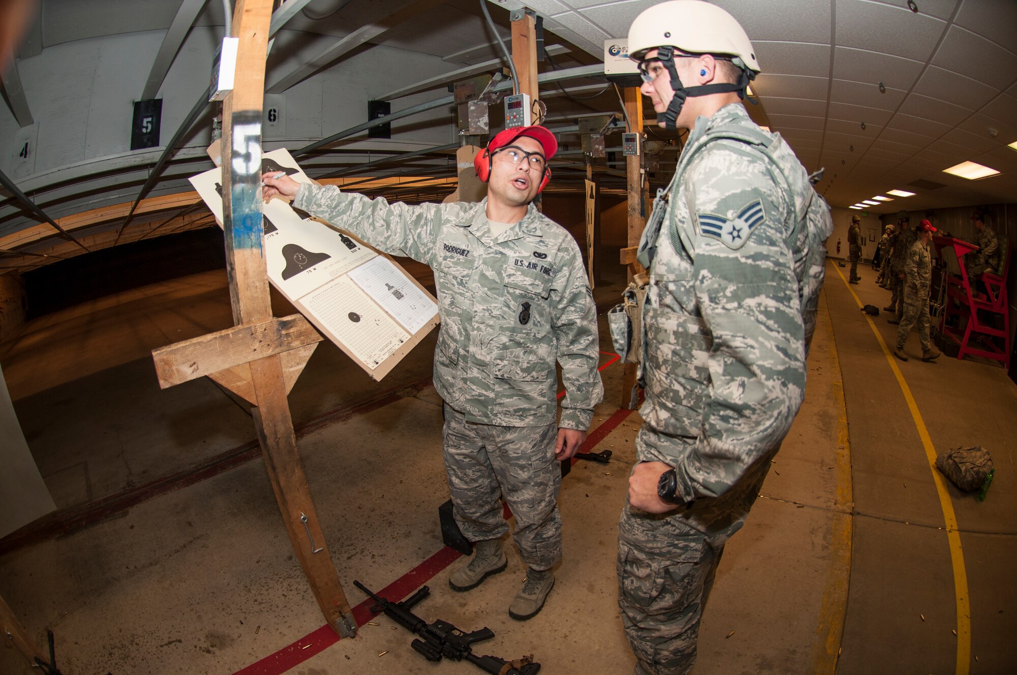 Senior Airman Elijah Rodriguez, 419th Security Forces Squadron fire team member, scores the target of Senior Airman Carson Zachreson, one of the newest Airmen on the wing’s Explosive Ordnance Disposal team. (U.S. Air Force photo/Senior Airman Crystal Charriere)