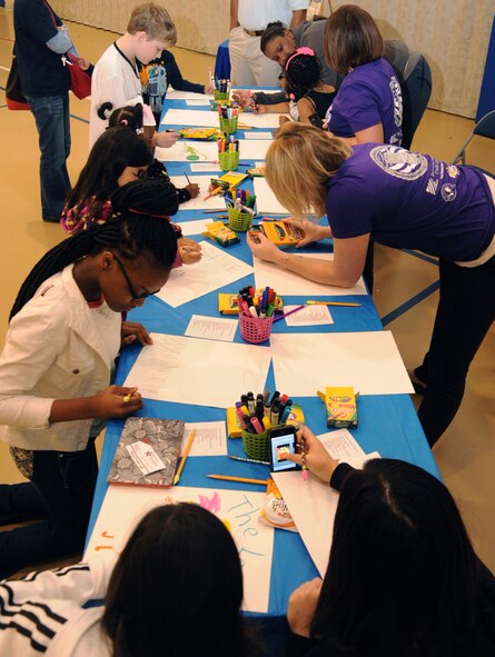 Children create a movie poster during the Books on Bases event at the Youth Center on Barksdale Air Force Base, La., April 13, 2013. The event had a book reading, arts and crafts, games and raffles, and was held to bring military families together to promote them reading together. (U.S. Air Force photo/Senior Airman Sean Martin)