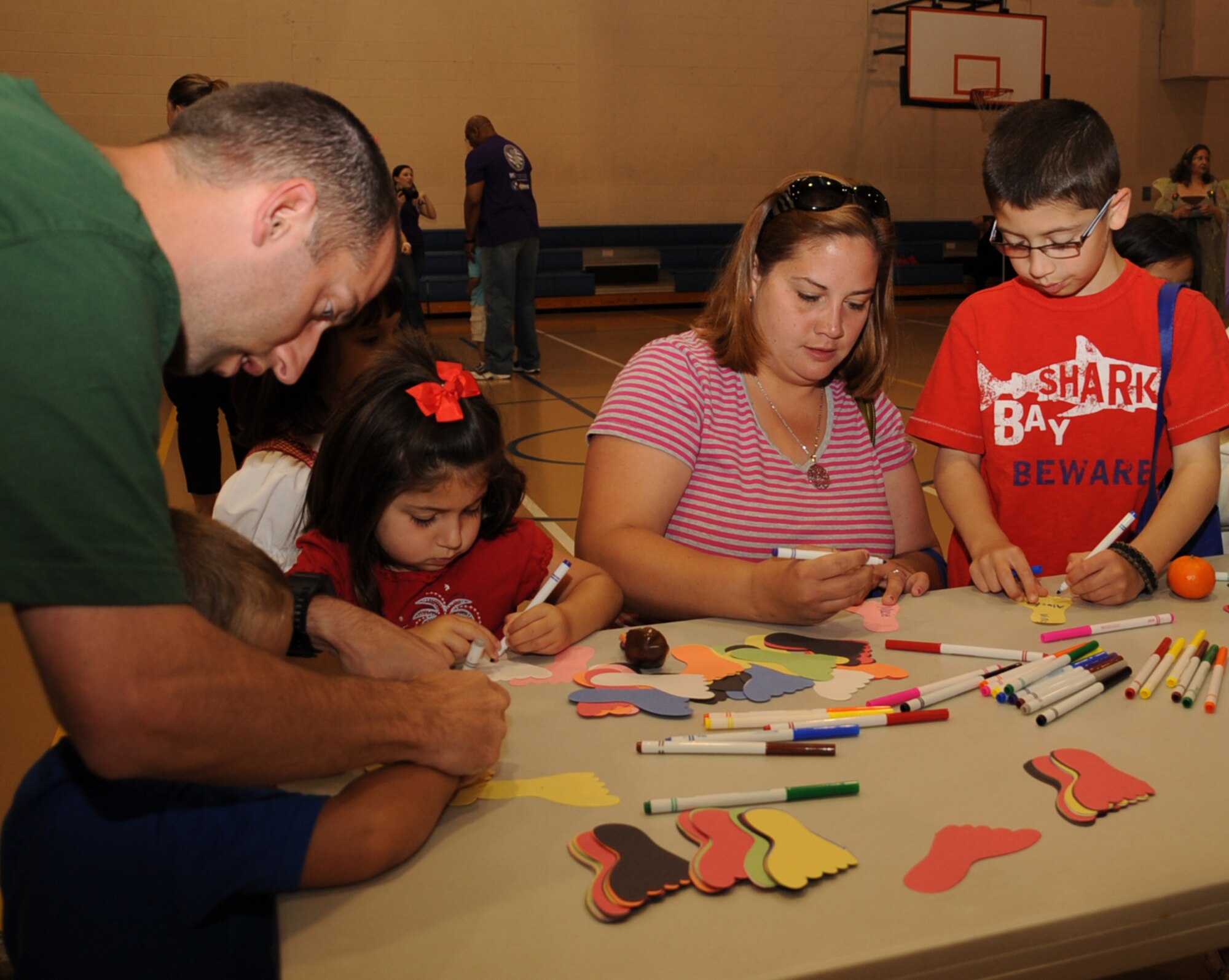 The Selman Family plays a game during the Books on Bases event at the Youth Center on Barksdale Air Force Base, La., April 13. The object of the game was to write down places you have lived and then place them on a map. Books on Bases was created by Blue Star Families to positively impact the lives of military children through the power of reading. (U.S. Air Force photo/Senior Airman Sean Martin)