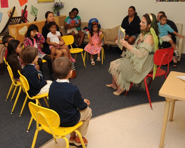 A volunteer reads to children during the Books on Bases event at the Youth Center on Barksdale Air Force Base, La., April 13, 2013. Books on Base was created by Blue Star Families to positively impact the lives of military children through the power of reading. The event was held as part of Month of the Military Child. (U.S. Air Force photo/Senior Airman Sean Martin)