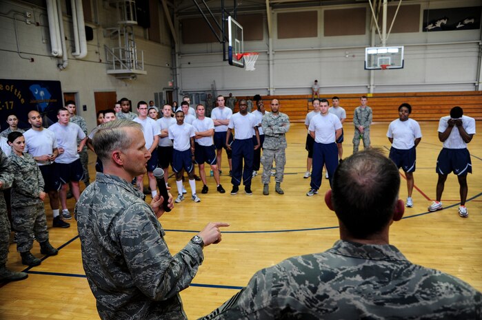 Col. Darren Hartford, 437th Airlift Wing commander, speaks to  participants of  the Dorm Challenge April 12, 2013, at the Fitness Center at Joint Base Charleston - Air Base, S.C. The quarterly dorm competition is a Wing initiative intended to encourage and incorporate all aspects of Comprehensive Airman Fitness while encouraging resident interaction and camaraderie. The Dorm Challenge consisted of push-ups, sit-ups, cornhole and dodgeball. (U.S. Air Force photo/Staff Sgt. Rasheen Douglas) 