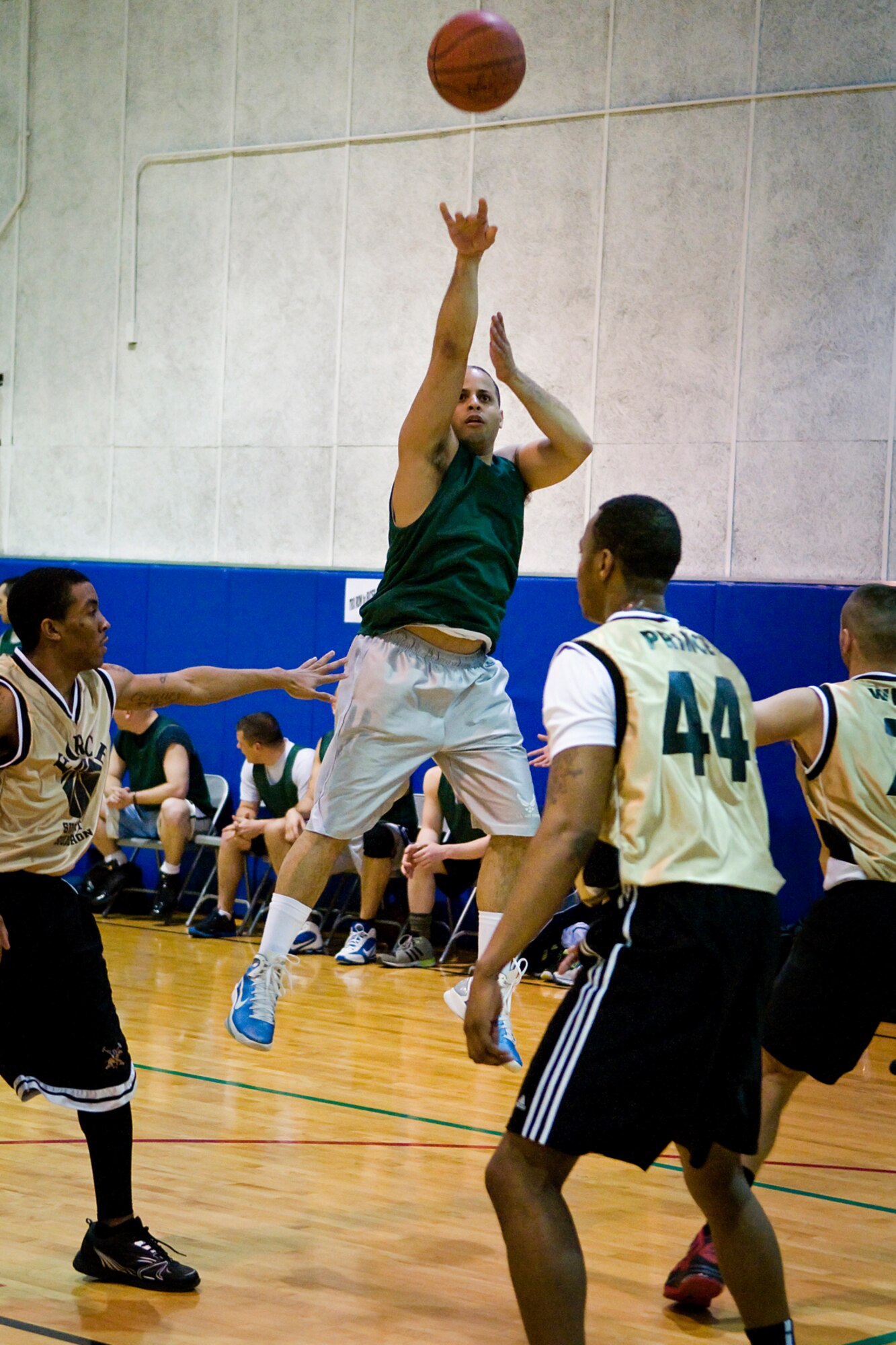 GRISSOM AIR RESERVE BASE, Ind. -- Carl Berry, 434th Security Forces Squadron team guard, goes for a basket as members from the 434th Force Support Squadron close in during an annual basketball tournament here April 13. The Cops slam dunked Force Support in a game ending score 29-20. (U.S. Air Force graphic/Senior Airman Jami K. Lancette)
