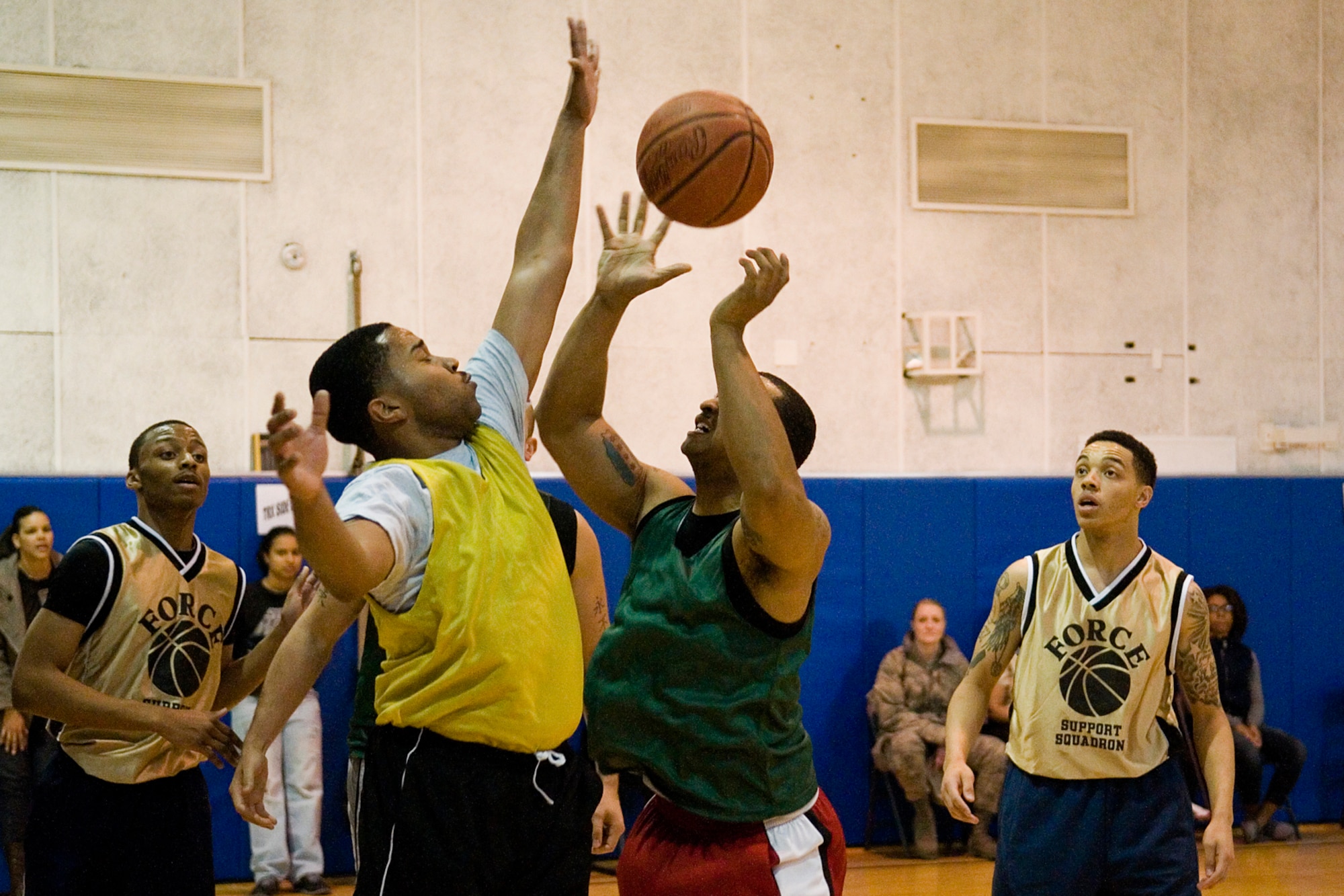 GRISSOM AIR RESERVE BASE, Ind. -- Clarence Ayers, 434 Security Forces Squadron team member, and Brandon Barnes-Carter, 434th Force Support Squadron team member, close in for a ball as Dustin Pervine and Det Rek Suggs, both FSS team members, look on during an annual basketball tournament here April 13. SFS ended the tournament with victory over FSS, 29-20. (U.S. Air Force graphic/Senior Airman Jami K. Lancette) 
