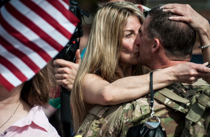 Chief Master Sgt. James Donnelly, 560th Red Horse Squadron kisses his fiancé after returning from the unit’s first six-month deployment to the Southwest Asia region April 11, 2013, at Joint Base Charleston – Air Base, S.C. The group arrived back home to a cheering crowd of family and friends. (U.S. Air Force photo/ Senior Airman Dennis Sloan)