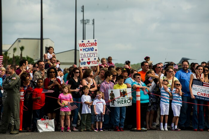 Friends and family members of the 560th Red Horse Squadron wait for their loved ones to exit a plane after returning home from deployment to the Southwest Asia region April 11, 2013, at Joint Base Charleston – Air Base, S.C. The group arrived back home to a cheering crowd of family and friends. (U.S. Air Force photo/ Senior Airman George Goslin)