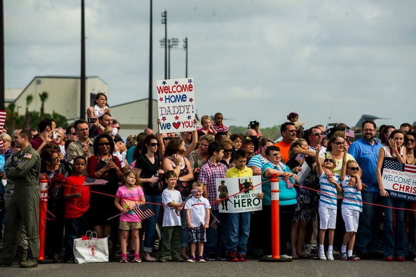 Friends and family members of the 560th Red Horse Squadron wait for their loved ones to exit a plane after returning home from deployment to the Southwest Asia region April 11, 2013, at Joint Base Charleston – Air Base, S.C. The group arrived back home to a cheering crowd of family and friends. (U.S. Air Force photo/ Senior Airman George Goslin)