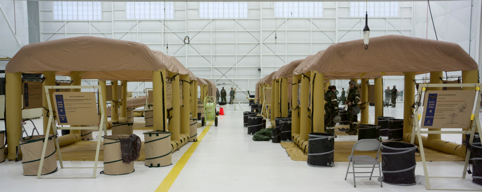 Portable decontamination equipment is in operation at the 128th Air Refueling Wing for an Ability to Survive and Operate exercise, April 14, 2013, at Gen. Mitchell Airfield, Wis. The training exercise helps prepare airmen from the Wisconsin Air National Guard for operations in chemical, biological, radioactive, and nuclear environments. (Air National Guard photo by Staff Sgt. Christopher Wenzel/Released)