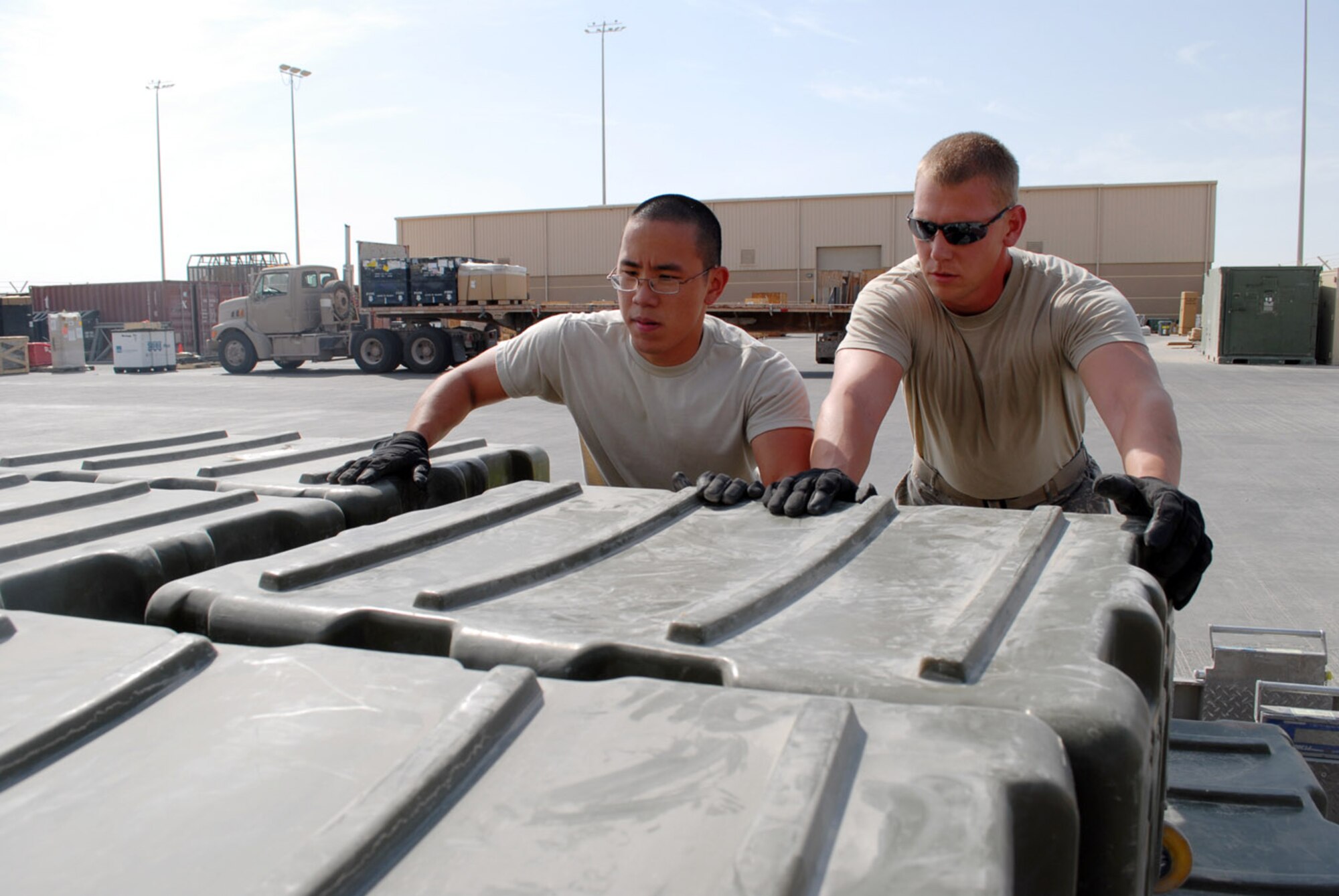 SOUTHWEST ASIA -- Outbound cargo NCO Staff Sgt. Ryan Wollenzin and specialist Airman 1st Class Tachun Kao, 379th Expeditionary Logistics Readiness Squadron, prepare a pallet with robots. These robots were used by members of the 379th Expeditionary Civil Engineer Squadron Explosive Ordnance Disposal Flight, who later prepared robots and supporting equipment for shipment back to the United States from here. (U.S. Air Force photo/Master Sgt. Christian Michael)