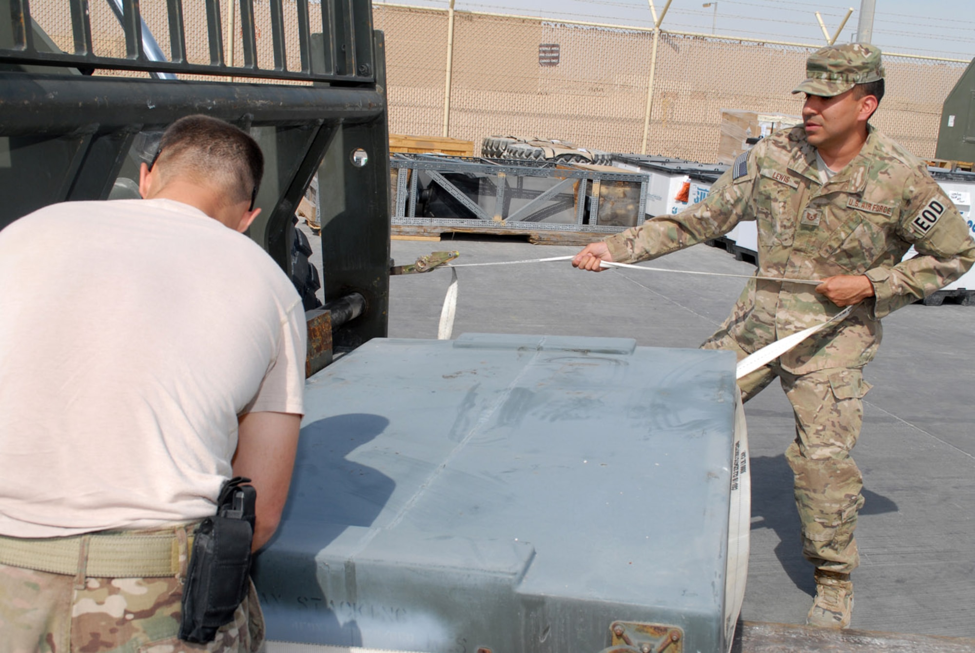 SOUTHWEST ASIA -- Outbound cargo NCO Staff Sgt. Ryan Wollenzin, 379th Expeditionary Logistics Readiness Squadron, and Tech. Sgt. Kenneth Lewis, NCO in charge of the 379th Expeditionary Civil Engineer Squadron Explosive Ordnance Disposal Flight, prepare robotic equipment for shipping back to the United States, Feb. 28. EOD prepared robots and supporting equipment for shipment back to the U.S. from here. (U.S. Air Force photo/Master Sgt. Christian Michael)