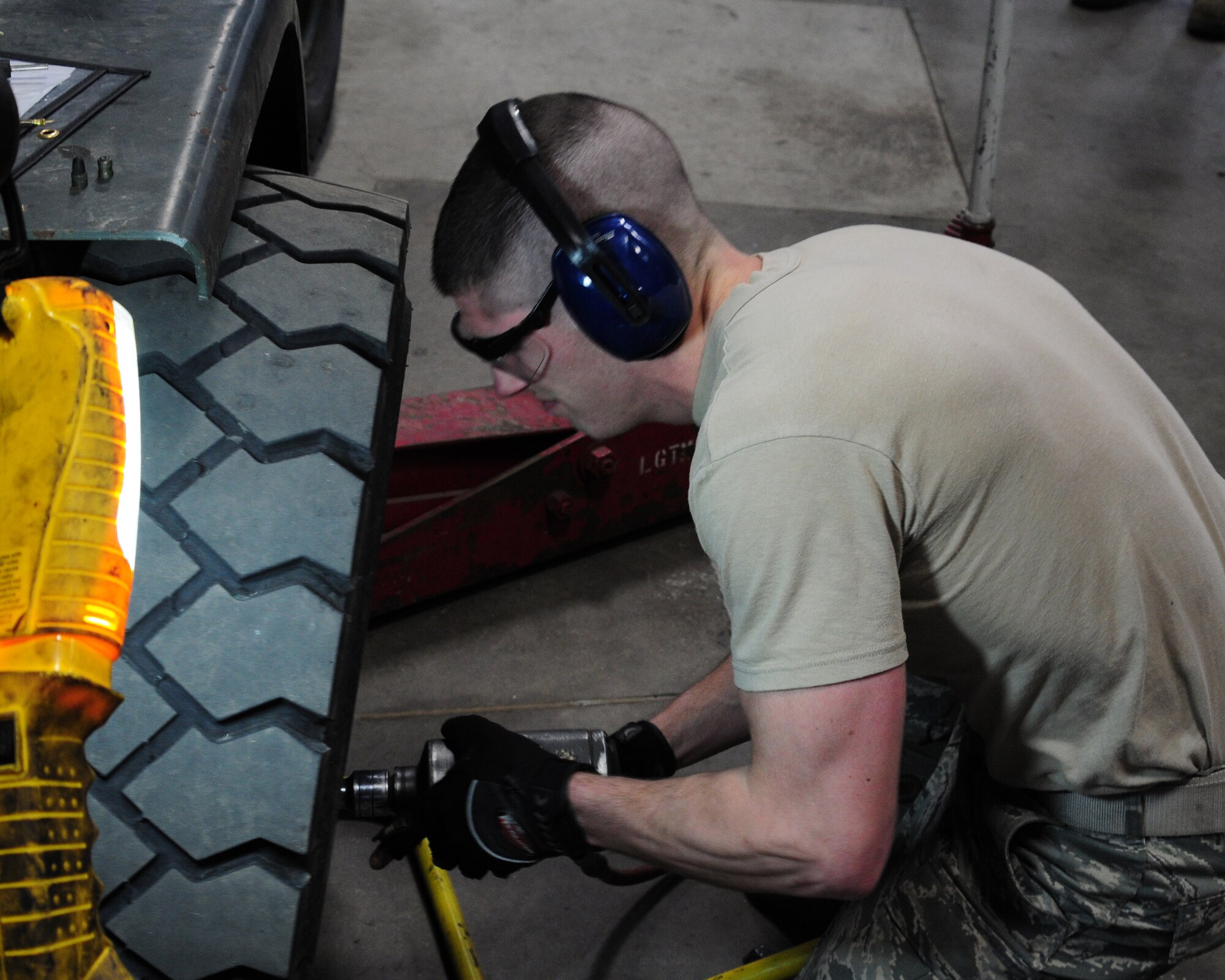 YOUNGSTOWN AIR RESERVE STATION, Ohio—Senior Airman Ryan Gruda, a member of the vehicle maintenance section for the 910th Logistics Readiness Squadron, works on removing a tire from a 10K forklift.  (U.S. Air Force photo/TSgt Rick Lisum)