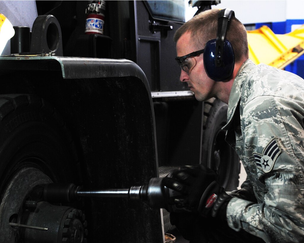 YOUNGSTOWN AIR RESERVE STATION, Ohio—Senior Airman Matt Cox, a member of the vehicle maintenance section for 910th Logistics Readiness Squadron, works on removing a tire from a 10K forklift, here, April 7th.  (U.S. Air Force photo/TSgt Rick Lisum)