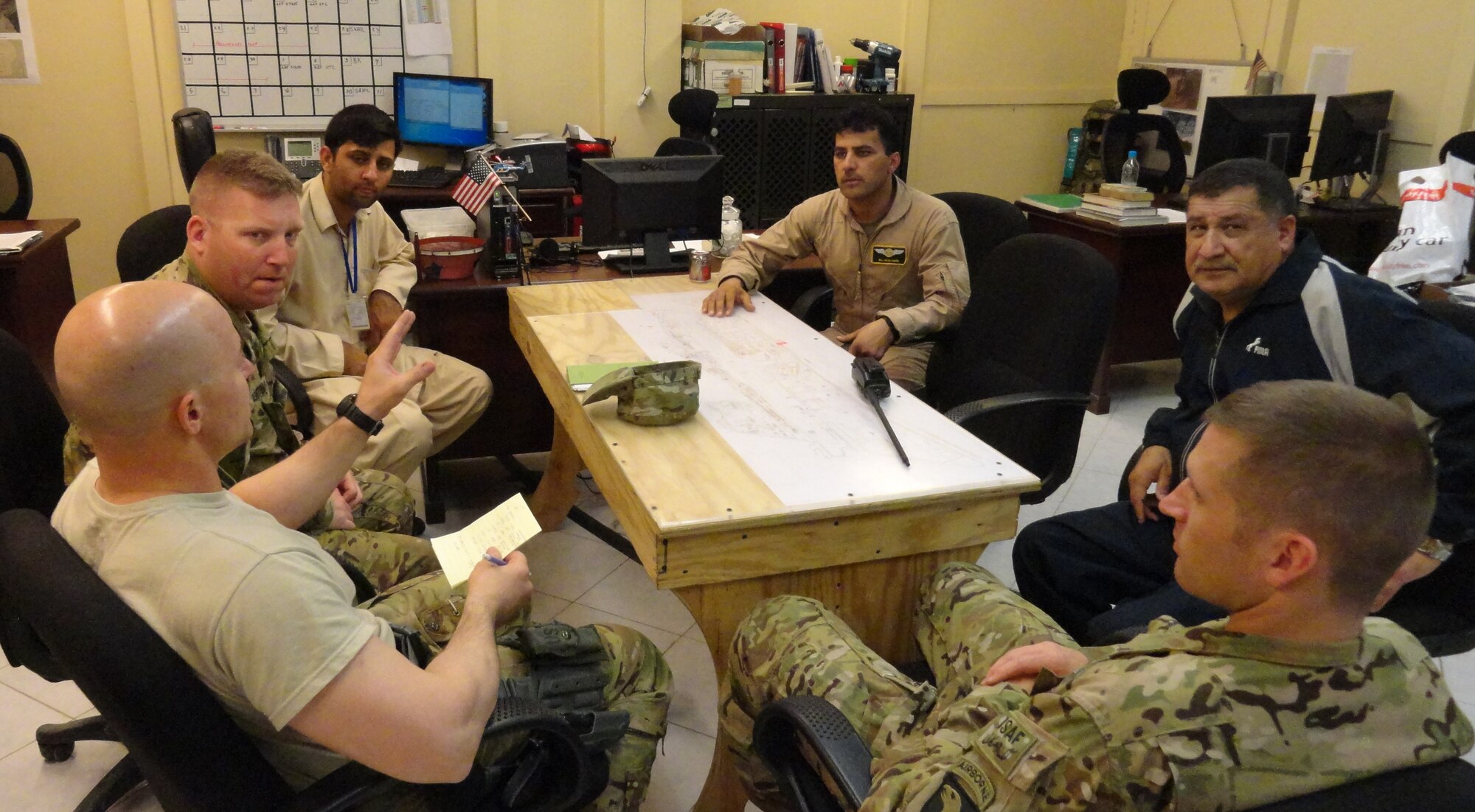Afghan Air Force members and NATO Air Training Command-Afghanistan advisors work together to plan and execute and emergency resupply mission April 12, 2013 at Jalalabad Airfield, Afghanistan. The AAF Detachment at JAF completed the mission following an insurgent attack on a remote outpost in eastern Afghanistan in coordination with the Ministry of Defense, the 201st Corps from Kabul Air Wing and Task Force Dragon. (courtesy photo)