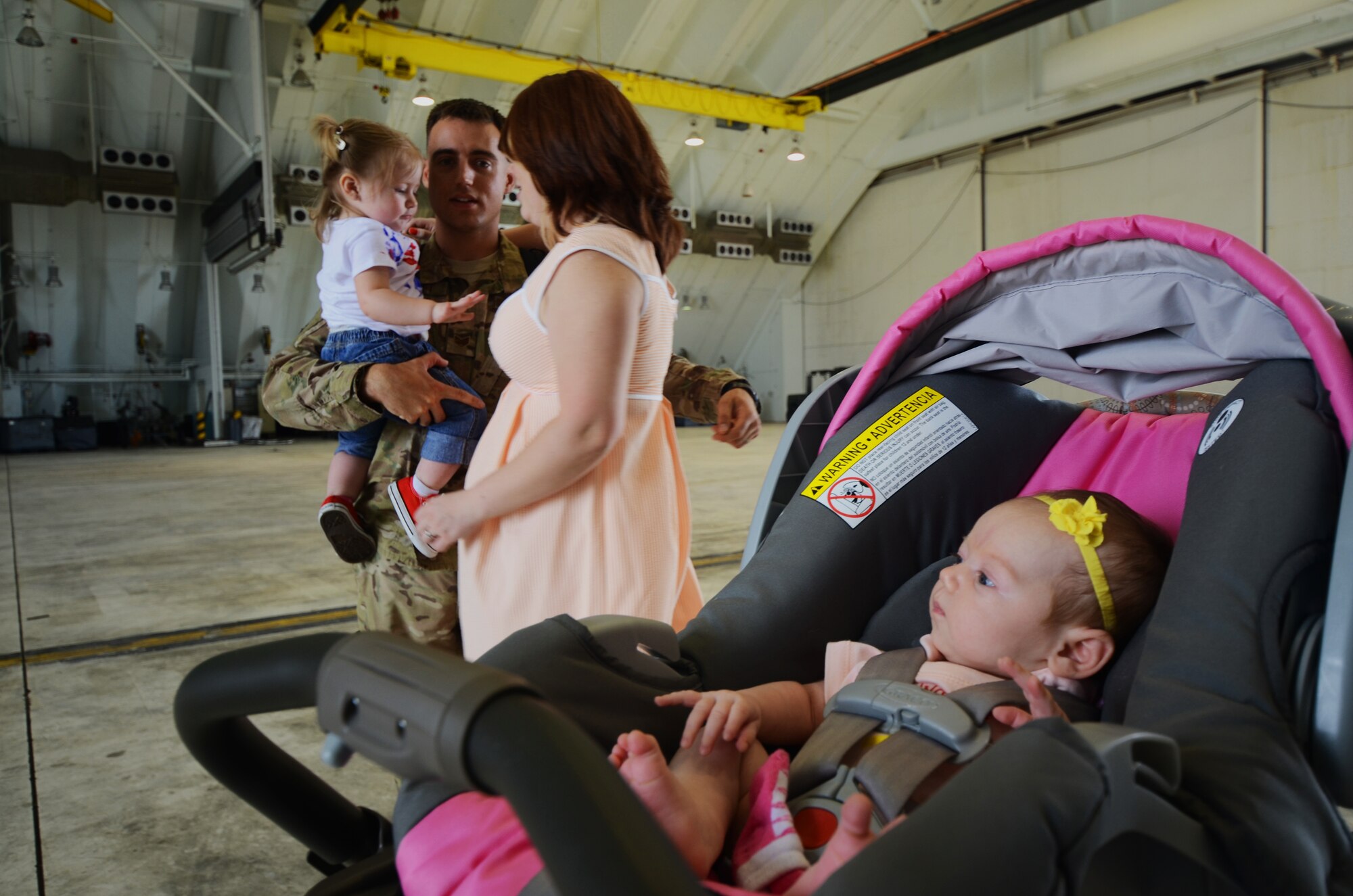 ANDERSEN AIR FORCE BASE, Guam—Staff Sgt. Bryan Schrift, 554th RED HORSE Squadron vehicle maintenance technician, and his family prepare to leave after a homecoming in Hangar 1 on Andersen Air Force Base, Guam, April 16, 2013. The 554th RHS was deployed for seven months to Southwest Asia where they supported construction projects for eight different sites in and around the region. (U.S. Air Force photo by Senior Airman Benjamin Wiseman/Released)