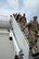 ANDERSEN AIR FORCE BASE, Guam — Airmen from the 554th RED HORSE Squadron exit a plane on Andersen Air Force Base, Guam, April 16, 2013. The 554th RHS returned from a seven month deployment to Southwest Asia where they supported construction projects for eight different sites in and around the region. (U.S. Air Force photo by Senior Airman Benjamin Wiseman/Released)