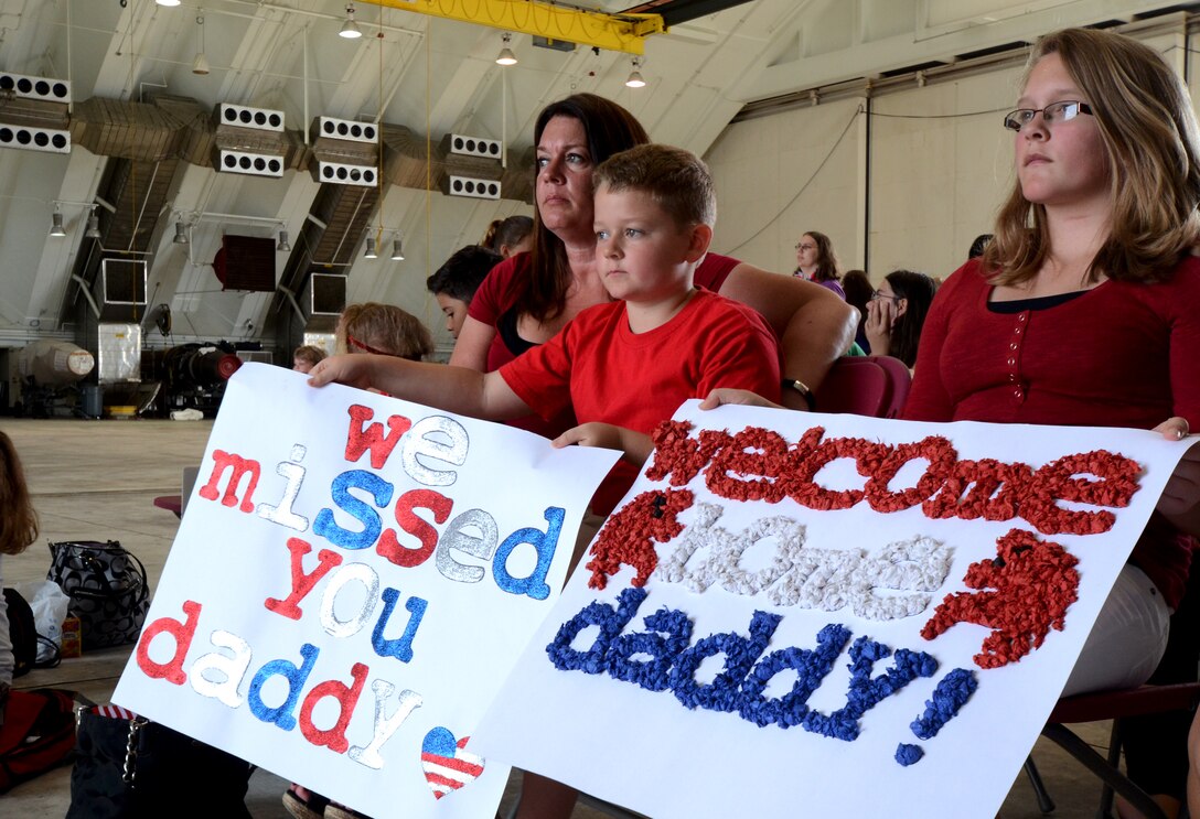 ANDERSEN AIR FORCE BASE, Guam — Family and friends wait in Hangar 1 on Andersen Air Force Base, Guam, April 16, 2013, for the return of the 554th RED HORSE Squadron. The 554th RHS was deployed for seven months to Southwest Asia where they supported construction projects for eight different sites in and around the region. (U.S. Air Force photo by Senior Airman Benjamin Wiseman/Released)