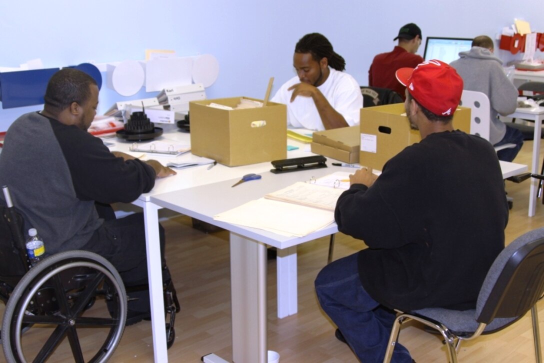 A team of veterans working to clean and mend documents from Walter F. George Lake.
