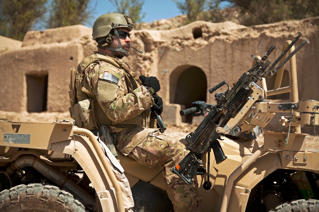 A coalition force member provides security during a patrol with Afghan special forces to escort a district governor in Helmand province, Afghanistan, April 14, 2013. Afghan forces have been taking the lead in operations to bring security and stability to the people of Afghanistan.