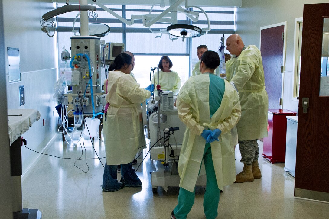 Army Chief of Staff Gen. Ray Odierno, his wife, Linda, Sgt. Maj. of the Army Raymond F. Chandler III and his wife, Jeanne, meet a patient during a visit to Brooke Army Medical Center on Joint Base San Antonio-Fort Sam Houston, Texas, April 16, 2013.