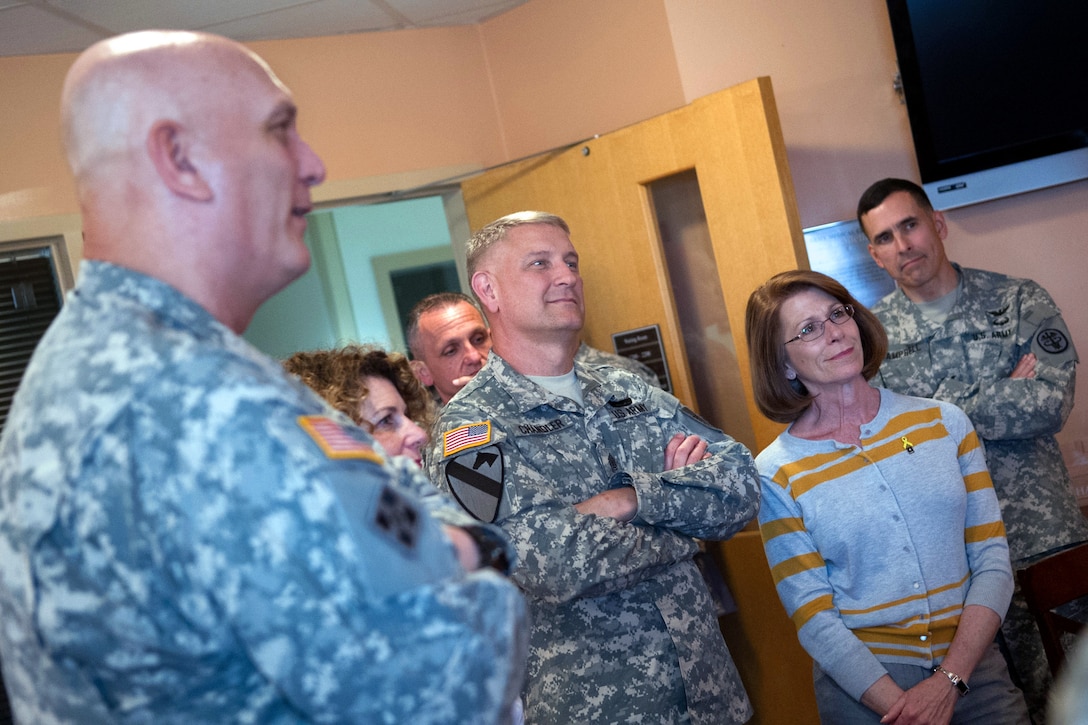 Army Chief of Staff Gen. Ray Odierno, left, his wife, Linda, Sgt. Maj. of the Army Raymond F. Chandler III and his wife, Jeanne, listen to a wounded warrior during a visit to Brooke Army Medical Center in Joint Base San Antonio -Fort Sam Houston, Texas, April 16, 2013.