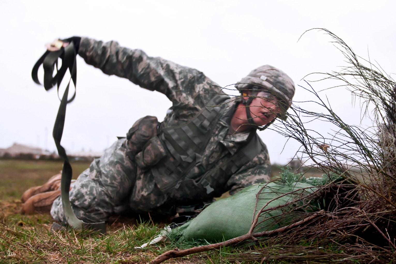 Army Pfc. Steven Williams throws a grappling hook to check for booby-traps  before crossing a