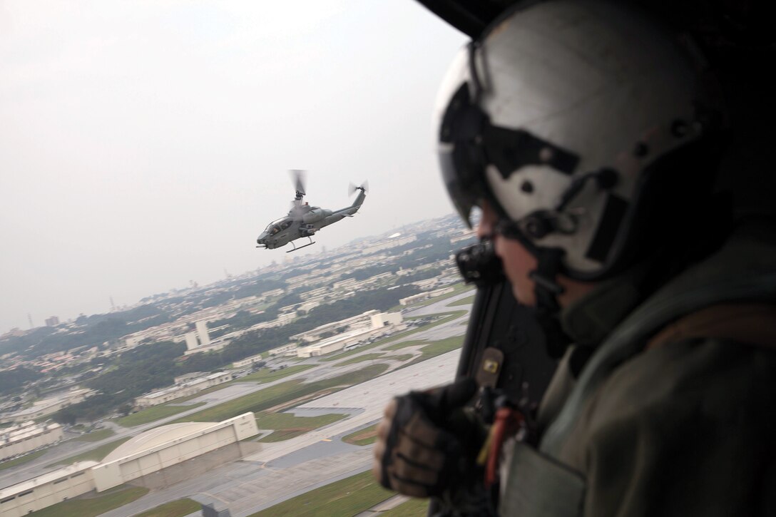 An AH-1W Super Cobra helicopter and a UH-1Y helicopter depart Kadena Air Base for surface-to-air missile simulation training on Ie Shima April 12. Marines used foam missiles nicknamed “smokey SAMs” during the training to allow pilots to practice evasive maneuvers. The aircraft are with Marine Medium Helicopter Squadron 262 (Reinforced), 31st Marine Expeditionary Unit, III Marine Expeditionary Force. 