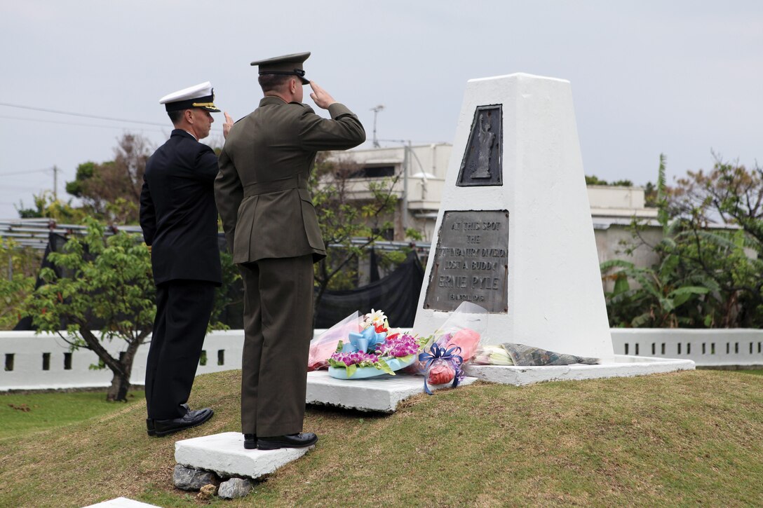Navy Capt. Richard Weathers and 1st Lt. Ryan Ackland salute Ernie Pyle’s memorial at Ie Shima April 14 during the 69th memorial ceremony in honor of Pyle’s service as a war correspondent. Pyle was a correspondent during World War II and reported alongside service members in the Europe, Africa and Pacific theaters. He was killed while reporting on Ie Shima in 1945, just months before the end of the war. Weathers is the commanding officer of Commander Fleet Activities Okinawa, and Ackland is the officer in charge of operations for Ie Shima Training Facility.