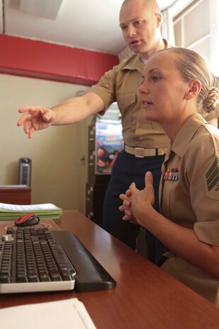 Staff Sgt. Jasen D. Kerr, a career planner serving with Headquarters Battalion, 1st Marine Division, instructs Sgt. Jessica L. Bauerlien, a student in the Basic Career Planners Course at Recruiters School, Marine Corps Recruit Depot San Diego, on how to use career planning systems here, April 17, 2013. Bauerlien, a native of Manchester, Md., visited Kerr, a native of Jefferson, Md., to receive on the job training as part of the course. After graduating from the course, Bauerlien will be assigned as a career planner in Okinawa, Japan
