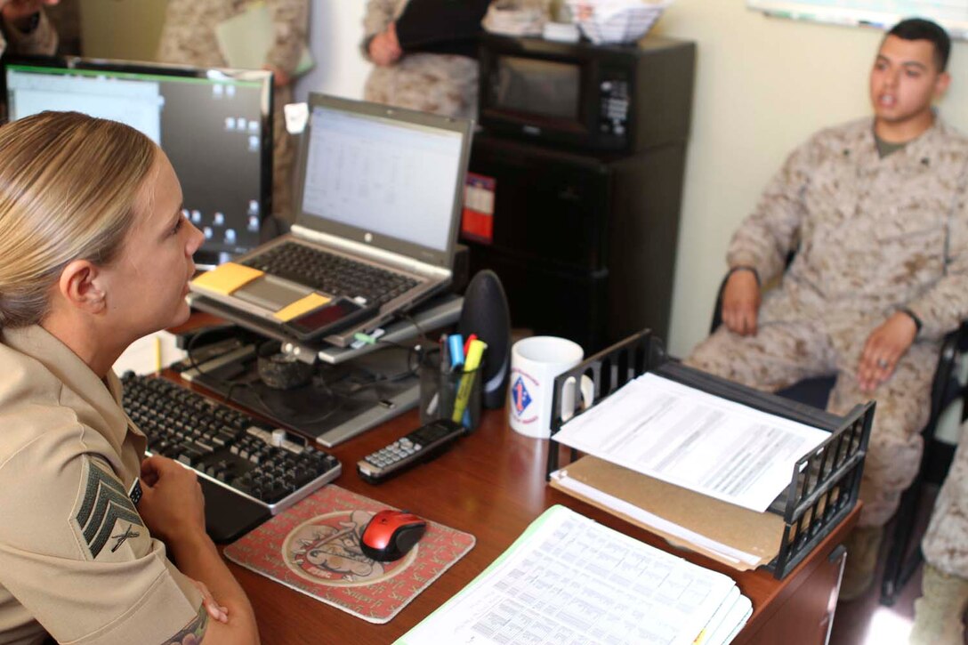 Staff Sgt. Jasen D. Kerr, a career planner serving with Headquarters Battalion, 1st Marine Division, instructs Sgt. Jessica L. Bauerlien, a student in the Basic Career Planners Course at Recruiters School, Marine Corps Recruit Depot San Diego, on filling out interview forms here, April 17, 2013. Kerr, a native of Jefferson, Md., taught Bauerlien as part of a training exercise in the sixth week of the course. Bauerline recently reenlisted while in Afghanistan so she could have more opportunities to help her fellow Marines.