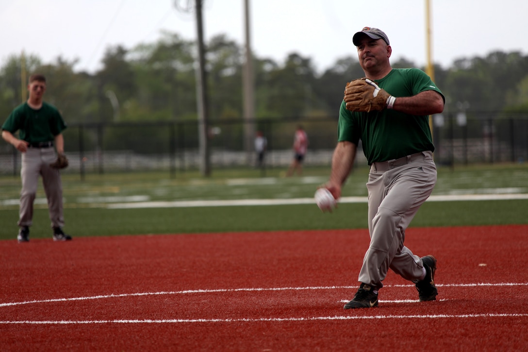 Glenn Cooper, 22nd Marine Expeditionary Unit pitcher and native of Virginia Beach, Va., throws out the first pitch during the team’s second intramural softball game of the year, playing against 8th Marine Regiment, at Marine Corps Base Camp Lejeune, N.C., April 16, 2013.  The MEU won both of its first two games in a doubleheader, 12-6 against the regiment and 19-9 against 2nd Marine Division. (Marine Corps photo by Lance Cpl. Caleb McDonald/Released)