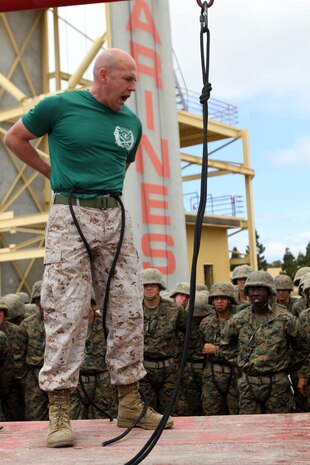 Staff Sgt. Patrick Sheedy, drill instructor, Instructional Training Company, Support Battalion, demonstrates how to create a hasty safety harness to rappel down the tower April 5. 