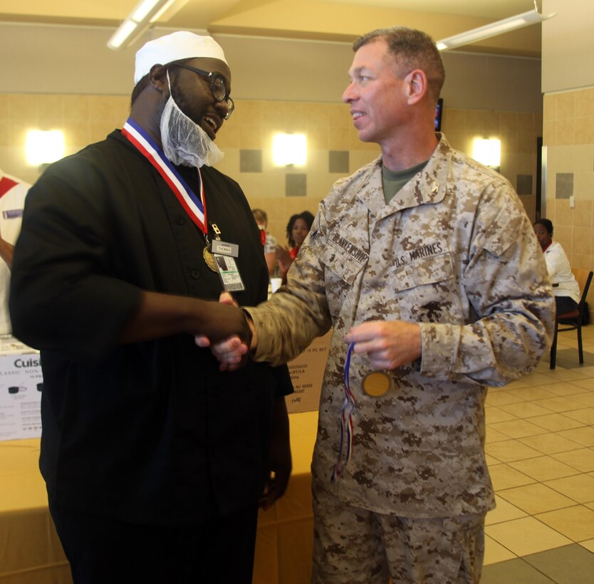 Thomas Goodwin, a chef with Sodexo, receives a medal from Col. Benjamin Blankenship,
Marine Corps Recruit Depot Parris Island operations officer, for winning
the Chef of the Quarter Competition April 11. The Chef of the Quarter competition
winners received a cookware set and took home the trophy for their mess hall.
