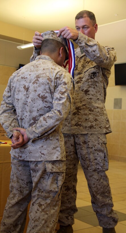Pfc. Sermin Sanchez, receives a medal from Col. Benjamin Blankenship, Marine Corps Recruit Depot Parris Island operations officer, for placing fourth in the Chef of the Quarter Competition April 11. Chefs from competing bases participated in a workshop and took a written test to earn their chance to compete for their spot as chef of
the quarter.