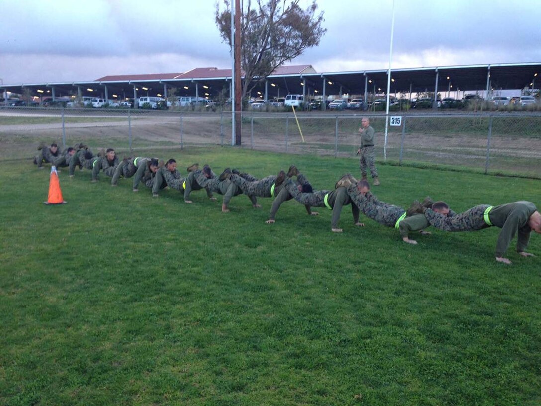 Corporals Leadership Summit 1-13 – Combat Conditioning – 2nd Squad executes a squad push-up during a Combat Conditioning Course.
